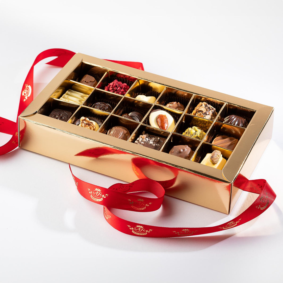 A chocolate box with displaying various chocolates inside.